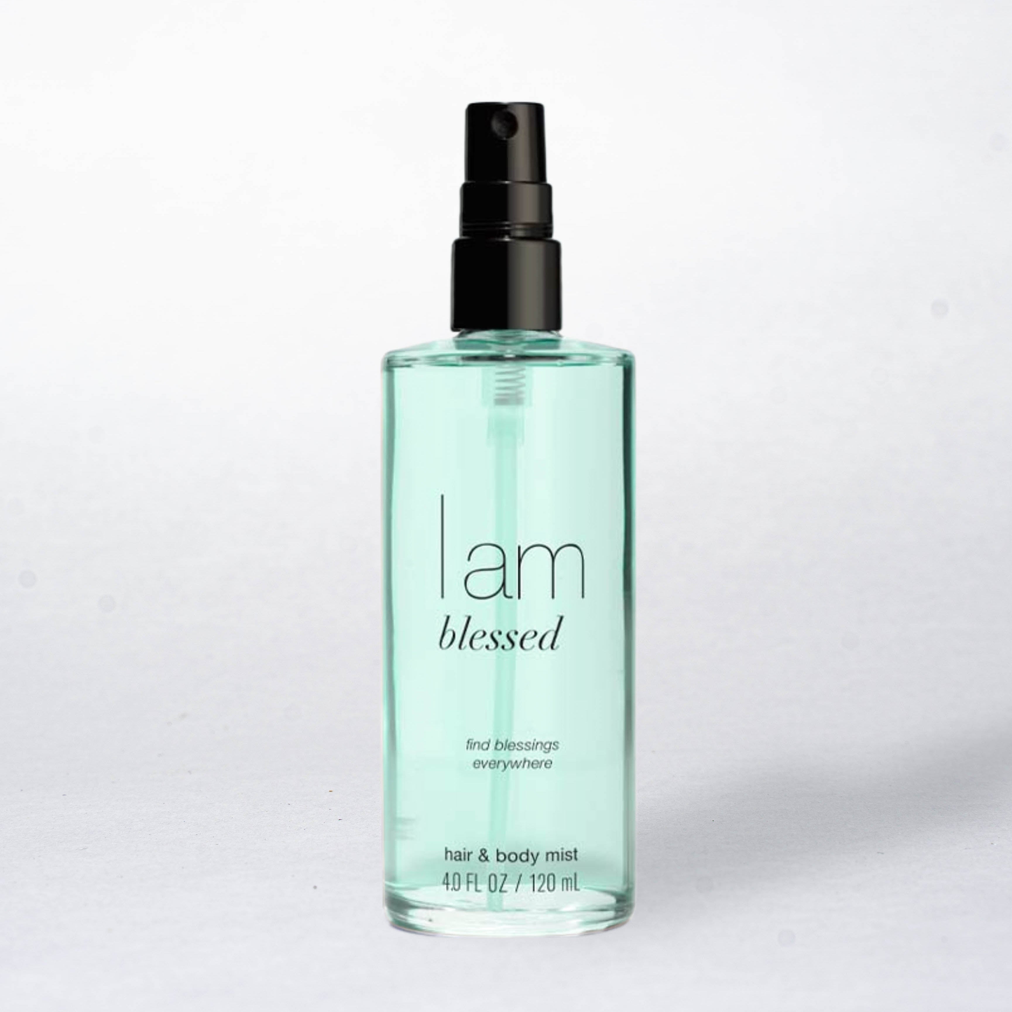 Hair and body mist bottle labeled 'I am blessed' on a light gray background