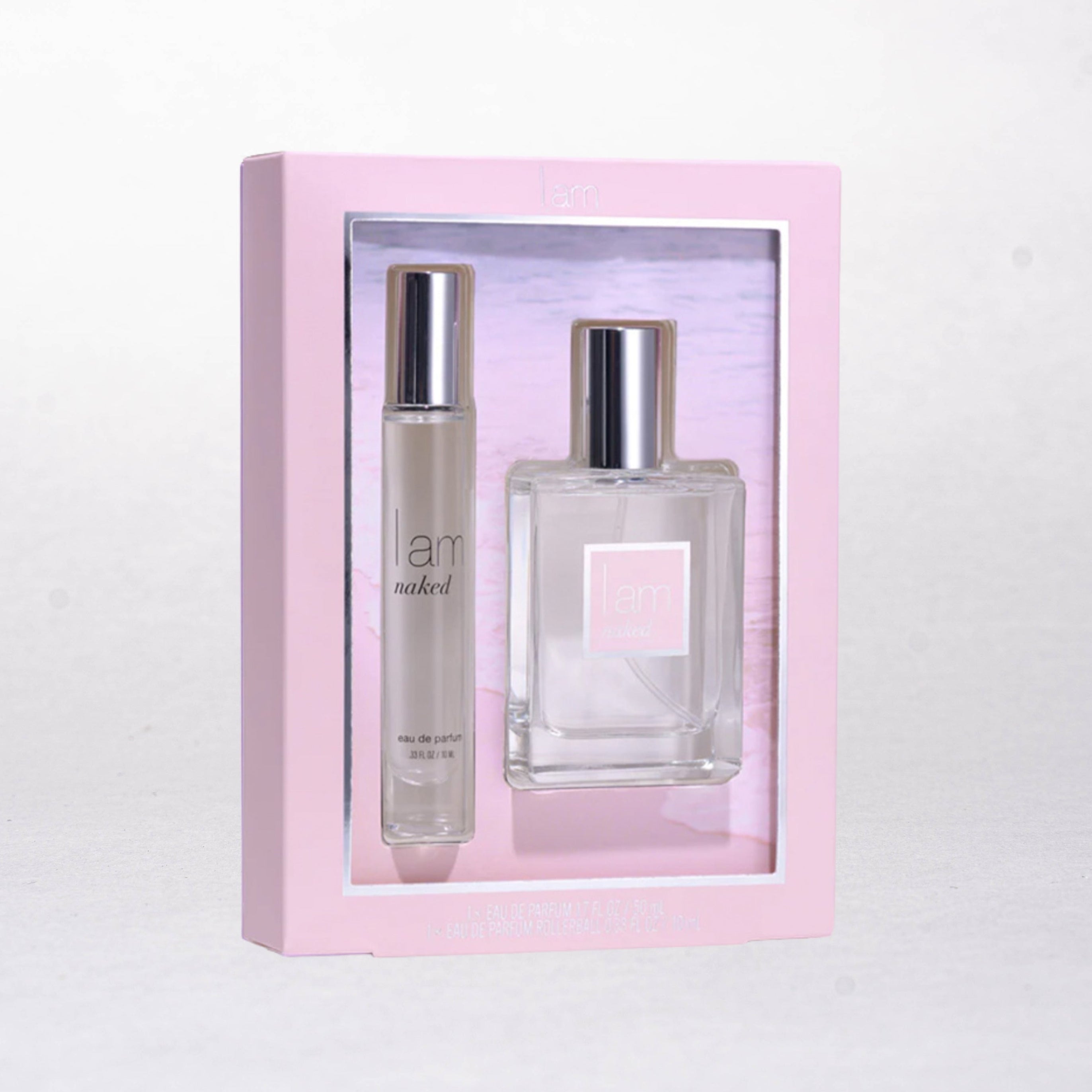 Two perfume bottles in a pink box on a white background