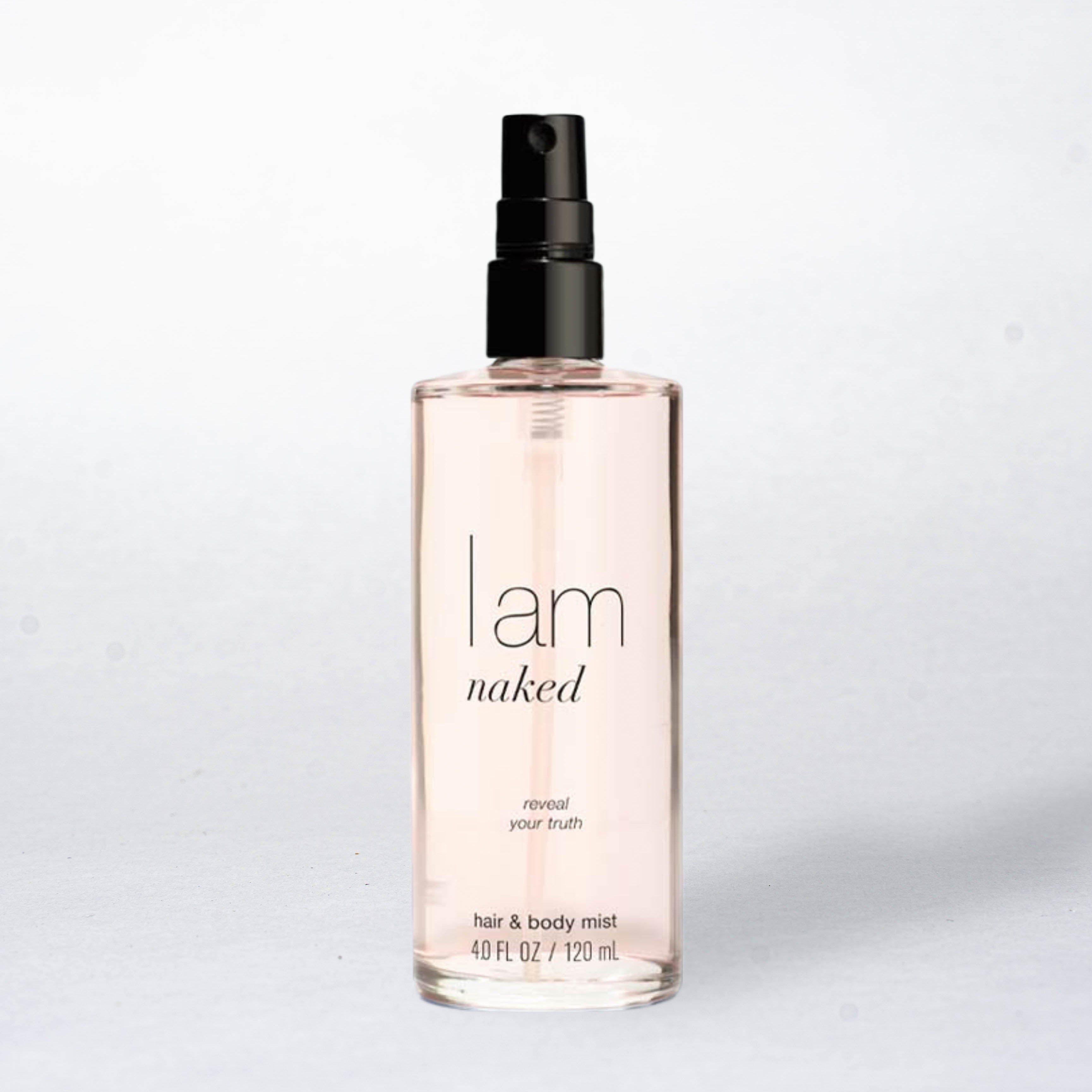 Hair and body mist bottle labeled 'I am naked' on a light gray background